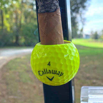 Yellow Callaway Cigar Ball holding a cigar