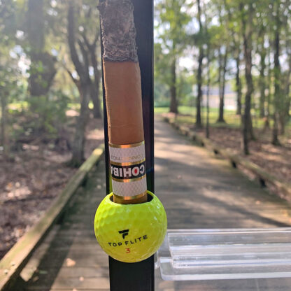 Yellow TopFlite Cigar Ball holding a Cohiba Connecticut cigar